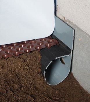 Closeup of a crawl space drainage system installed in Lexington