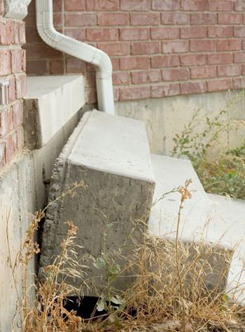 sinking outdoor concrete steps showing cracking and soil washout in Salem