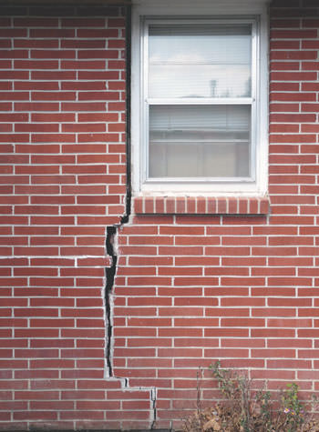 severe foundation wall cracks along a window in Derry