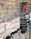 A completed installation of foundation push piers lifting a foundation in Arlington